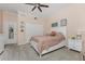 Bedroom showcasing neutral carpeting, large bed, and overhead ceiling fan at 1400 Beach Rd # 2, Englewood, FL 34223
