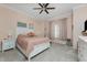 Bedroom featuring soft pink walls, a ceiling fan, and a large window at 1400 Beach Rd # 2, Englewood, FL 34223