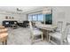 Cozy dining area with seating for four, located near the living space and water views at 1400 Beach Rd # 2, Englewood, FL 34223