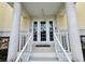 Inviting entrance with double doors, white columns, stairs, and well-maintained landscaping at 1400 Beach Rd # 2, Englewood, FL 34223