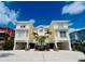 Exterior shot of a three-story home featuring palm trees and a blue sky at 1400 Beach Rd # 2, Englewood, FL 34223