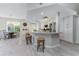The kitchen and dining area has bar stool seating, modern appliances, and bright light at 1400 Beach Rd # 2, Englewood, FL 34223