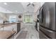 Bright kitchen with stainless appliances, granite counters, and a cozy window seat at 1400 Beach Rd # 2, Englewood, FL 34223
