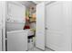 Cozy laundry room equipped with a stacked washer/dryer and shelving unit at 1400 Beach Rd # 2, Englewood, FL 34223