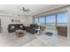 Open living area with comfy seating, gray flooring, and amazing water views at 1400 Beach Rd # 2, Englewood, FL 34223