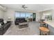 Bright, open living space with sleek gray floors and expansive windows showcasing beautiful water views at 1400 Beach Rd # 2, Englewood, FL 34223