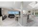 Open-concept living space with a modern kitchen, living room, dining area, and beautiful water views at 1400 Beach Rd # 2, Englewood, FL 34223