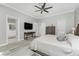 Spacious main bedroom with en-suite bathroom access, tv, and natural light at 1400 Beach Rd # 2, Englewood, FL 34223