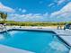 Backyard swimming pool showcasing beautiful blue water and outdoor seating with calming scenery at 1400 Beach Rd # 2, Englewood, FL 34223