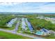 Community aerial view showcases waterfront homes, landscaping, and a pool creating a picturesque neighborhood setting at 14454 Worthwhile Rd, Port Charlotte, FL 33953