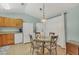 Cozy dining area with adjacent kitchen space featuring modern appliances and ample natural light at 14454 Worthwhile Rd, Port Charlotte, FL 33953