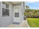 Inviting entryway featuring a welcoming door, adjacent window, and manicured landscaping at 14454 Worthwhile Rd, Port Charlotte, FL 33953