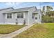 Charming single-story home featuring a well-maintained lawn and inviting walkway at 14454 Worthwhile Rd, Port Charlotte, FL 33953