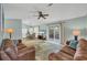 Inviting living room featuring sliding glass doors, comfortable seating, and a ceiling fan at 14454 Worthwhile Rd, Port Charlotte, FL 33953