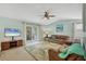 Comfortable living room featuring tropical-themed decor, with access to outdoor patio at 14454 Worthwhile Rd, Port Charlotte, FL 33953