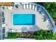 Aerial view of a rectangular community pool surrounded by lounge chairs and tables at 14454 Worthwhile Rd, Port Charlotte, FL 33953