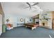 Spacious recreation room featuring a pool table, unique fireplace, comfortable seating, and natural light at 14454 Worthwhile Rd, Port Charlotte, FL 33953
