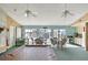 Large recreation room with pool views, ample seating, and a kitchenette, perfect for entertaining at 14454 Worthwhile Rd, Port Charlotte, FL 33953
