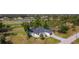 Aerial view of home with lake and golf course; lush landscaping with mature trees offers a peaceful and serene setting at 16 Pine Valley Ct, Rotonda West, FL 33947