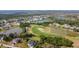 Aerial view of community with numerous homes, ponds, a golf course, and lush vegetation at 16 Pine Valley Ct, Rotonda West, FL 33947
