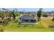 View of backyard and lanai pool area with lush landscaping and beautiful screened-in lanai at 16 Pine Valley Ct, Rotonda West, FL 33947