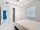 Well-lit bedroom with white walls, large windows, and a closet, offering a clean and modern look at 16 Pine Valley Ct, Rotonda West, FL 33947