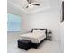 Bright bedroom featuring a ceiling fan, a tray ceiling, large windows, and modern decor at 16 Pine Valley Ct, Rotonda West, FL 33947