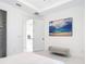 Bright bedroom featuring large TV, marble floors, and walk-in closet at 16 Pine Valley Ct, Rotonda West, FL 33947