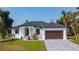 Charming single-story home with a manicured lawn, stone driveway, and a two-car garage, offering curb appeal at 16 Pine Valley Ct, Rotonda West, FL 33947