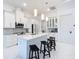Modern kitchen features an island with bar seating, pendant lighting, and stainless steel appliances at 16 Pine Valley Ct, Rotonda West, FL 33947