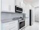 Elegant kitchen showcases white cabinets, granite countertops, and stainless steel appliances at 16 Pine Valley Ct, Rotonda West, FL 33947