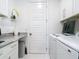 Clean and organized laundry room featuring modern appliances, ample counter space, and stylish decor at 16 Pine Valley Ct, Rotonda West, FL 33947