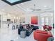 Bright living room boasts white walls, modern furnishings, and an open floor plan to the kitchen at 16 Pine Valley Ct, Rotonda West, FL 33947