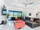 Bright living room boasts marble floors, modern lighting, and expansive sliding glass doors at 16 Pine Valley Ct, Rotonda West, FL 33947