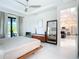 Bright main bedroom with a platform bed, view to the living room, and view to the pool at 16 Pine Valley Ct, Rotonda West, FL 33947