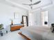 Bright main bedroom with a platform bed, dresser with mirror, and a view to the ensuite at 16 Pine Valley Ct, Rotonda West, FL 33947