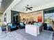Outdoor patio features comfortable seating, ceiling fan, tile floors, and easy access to the kitchen and pool area at 16 Pine Valley Ct, Rotonda West, FL 33947