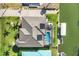 Aerial view showcasing the home's private pool, waterfront access, and solar panels at 1953 Georgia Ave, Englewood, FL 34224