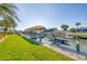 Waterfront backyard features a well-maintained lawn and a boat dock with a boat lift at 1953 Georgia Ave, Englewood, FL 34224