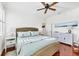Bedroom with wood floors, a ceiling fan, and a wicker bed frame at 1953 Georgia Ave, Englewood, FL 34224
