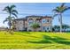 Charming two-story home featuring a lovely front yard, second story balcony, and beautiful landscaping at 1953 Georgia Ave, Englewood, FL 34224