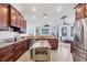 Spacious kitchen features wood cabinetry, stainless steel appliances, and a center island with seating at 1953 Georgia Ave, Englewood, FL 34224
