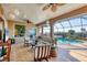 Spacious lanai with ample seating, views of the pool, and a glimpse of the lush green landscaping at 1953 Georgia Ave, Englewood, FL 34224