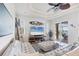 Bright living room boasts a beamed ceiling, cozy white sectional, and sliding doors leading to the outdoor area at 1953 Georgia Ave, Englewood, FL 34224