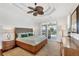 Spacious main bedroom featuring a ceiling fan and sliding glass doors to the screened-in lanai and pool area at 1953 Georgia Ave, Englewood, FL 34224