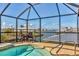 Inviting pool in a screened enclosure with waterfront views and outdoor seating at 1953 Georgia Ave, Englewood, FL 34224