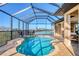 Sparkling pool area with screened enclosure, inviting views and patio seating for outdoor relaxation at 1953 Georgia Ave, Englewood, FL 34224