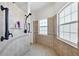 Shower with tiled walls, arched windows, a shower niche, and matte black hardware at 1953 Georgia Ave, Englewood, FL 34224