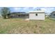 Expansive backyard showing the pool with full screen enclosure and small storage shed at 2140 Carnac St, Port Charlotte, FL 33952