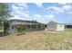 Wide backyard showing the pool with full screen enclosure and small storage shed and manicured landscaping at 2140 Carnac St, Port Charlotte, FL 33952